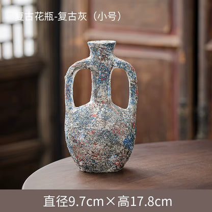 Decorative vase with multicolored speckled pattern on a wooden surface