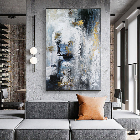Abstract painting in a modern living room with a gray sofa and orange pillow.