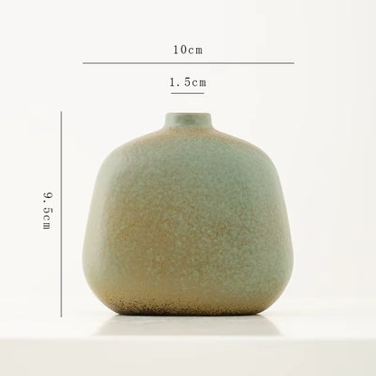 Green ceramic vase with dimensions on a white background