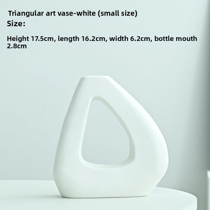 White triangular art vase on a light gray background with size information.
