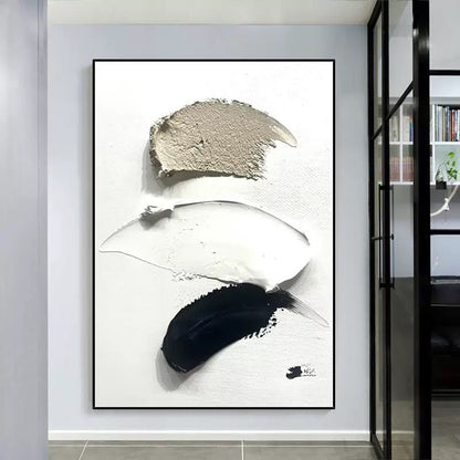 Abstract art piece with black, white, and gray brush strokes in a modern interior setting.
