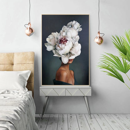 Framed artwork of a woman with floral headpiece in a bedroom setting