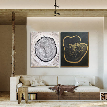 Modern living room with a white sofa, wooden side table, and abstract wall art.