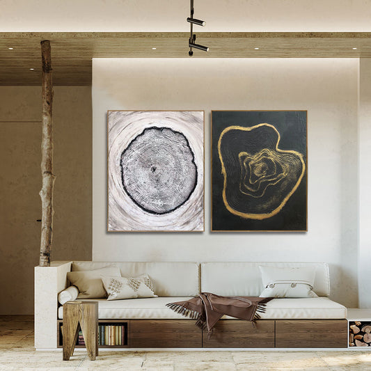 Modern living room with a white sofa, wooden side table, and abstract wall art.