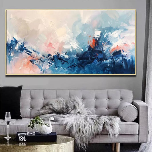 Abstract painting in a living room with a gray sofa and decorative items.