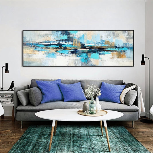 Living room with a gray sofa, blue pillows, and a large abstract painting on the wall.