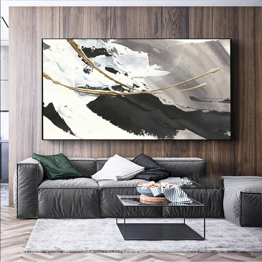 Living room with a large abstract painting on the wall above a gray sofa.