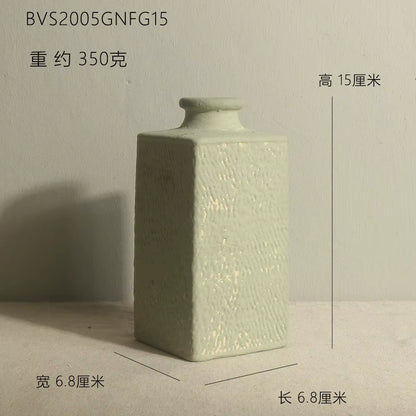 Green ceramic square bottle with dimensions on a neutral background