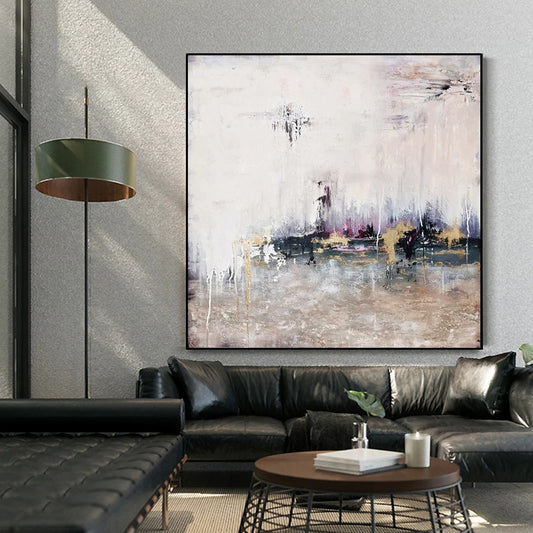 Modern living room with a black leather sofa, abstract painting, and a lamp.