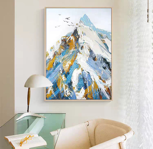 Abstract painting of a mountain scene in a modern interior setting with a chair and lamp.