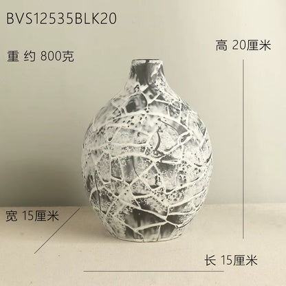 Decorative vase with cracked texture on a plain background