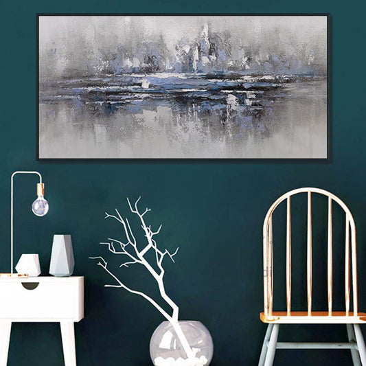 Abstract painting on a dark green wall with a white chair and decorative items.
