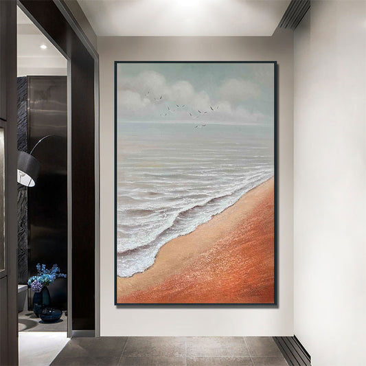 Framed artwork of a beach scene on a wall in a modern interior setting.
