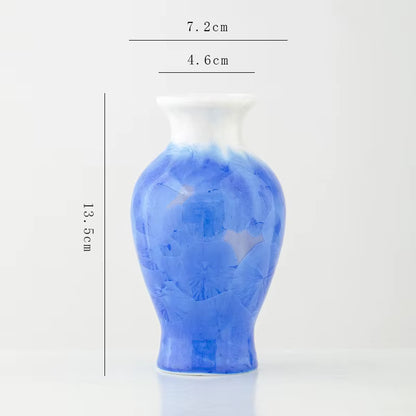 Blue ceramic vase with measurements on a white background