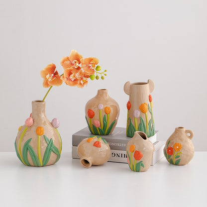 Set of ceramic vases with floral designs on a white background