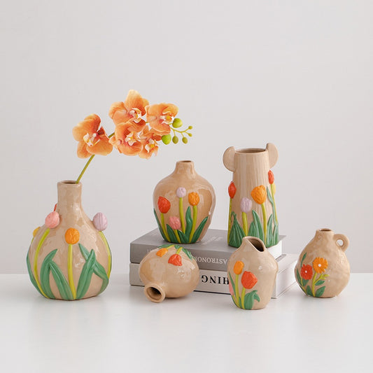Set of ceramic vases with floral designs on a white background