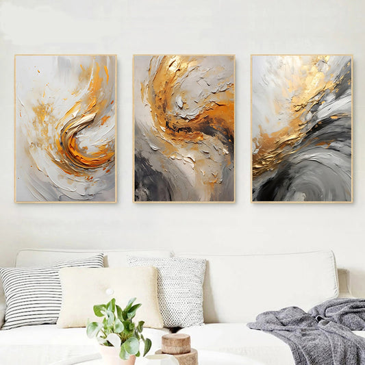 Three abstract art pieces in gold, gray, and white on a wall above a bed.