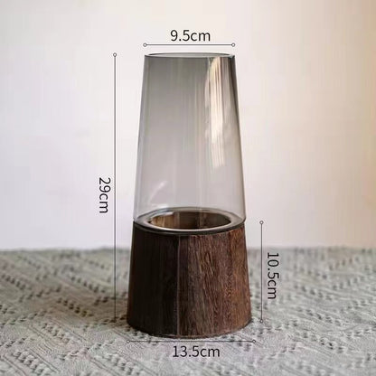 Votive candle holder with wooden base and glass cover, shown with measurements on a textured surface.