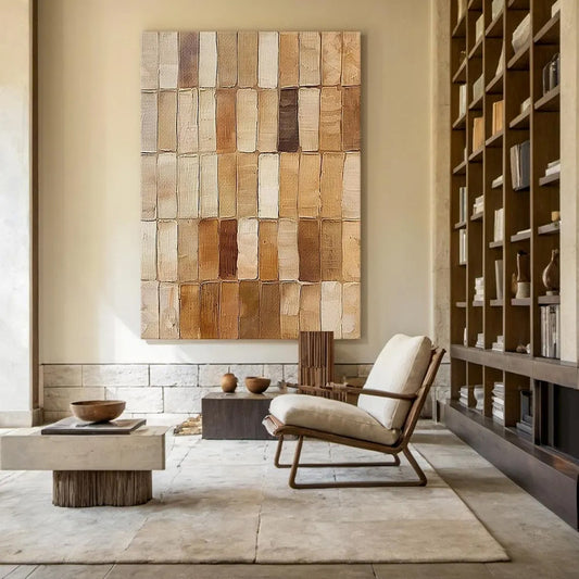 Modern living room with a textured wall art piece and a bookshelf.
