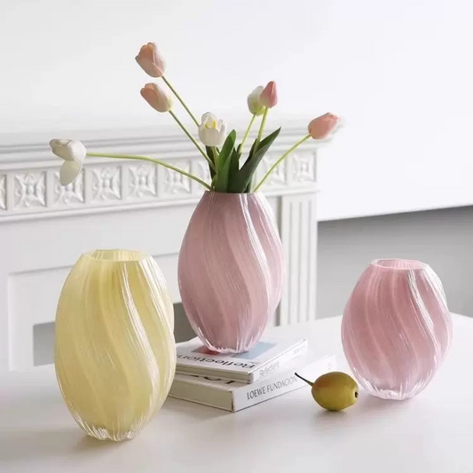 Three colorful vases on a table with a white background