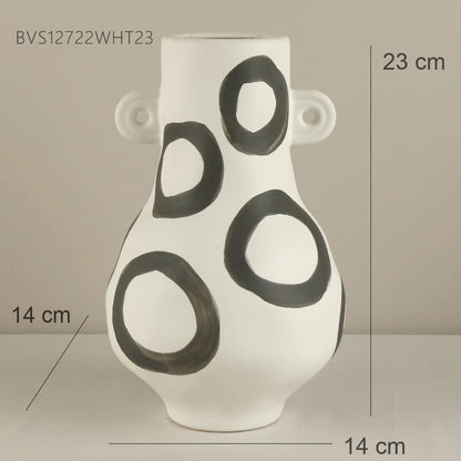 White vase with black circular patterns and measurements on a neutral background