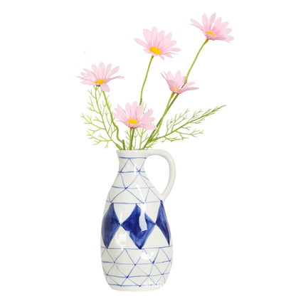Vase with geometric design and pink flowers on a white background