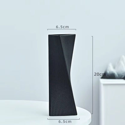 Black textured vase with dimensions on a light gray background
