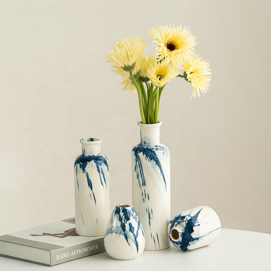 Set of ceramic vases with blue abstract patterns on a neutral background