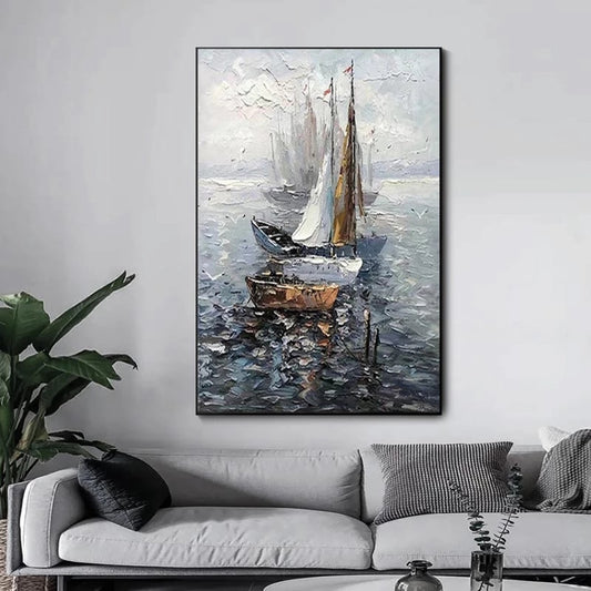 Framed painting of sailboats on water above a sofa in a living room.