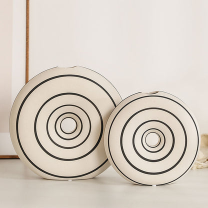 Two decorative plates with concentric circle patterns on a light background