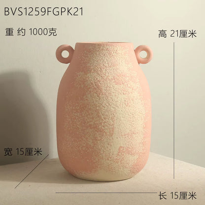 Pink textured vase with handles on a light background