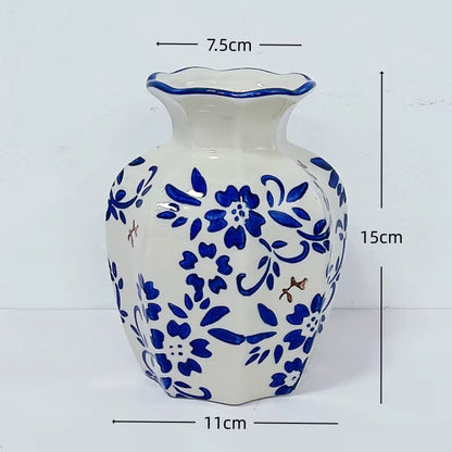 Ceramic vase with blue floral patterns and measurements on a white background