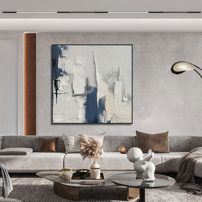 Modern living room with abstract art, gray sofa, and decorative items.