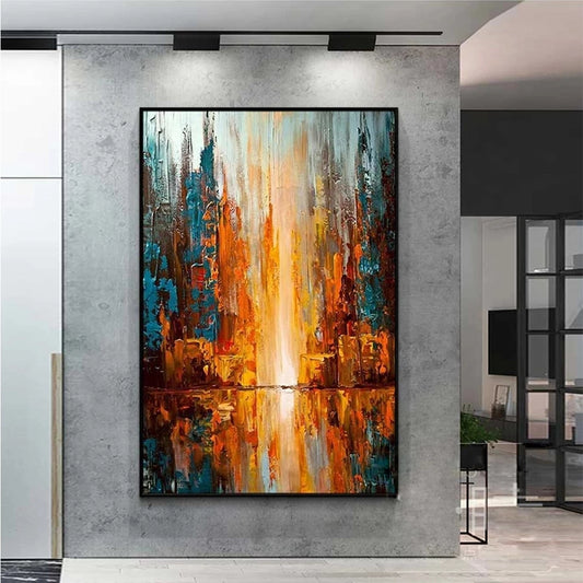 Abstract painting with warm colors on a gray wall in a modern interior setting.
