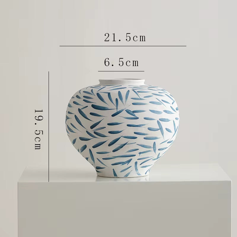 Ceramic jar with blue pattern on a white background, showing measurements.