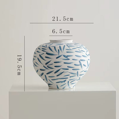 Ceramic jar with blue pattern on a white background, showing measurements.