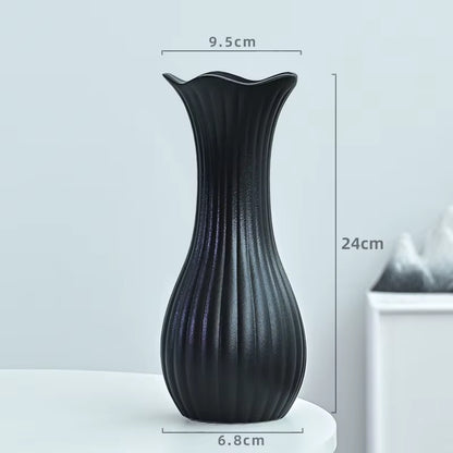 Black vase with dimensions on a light gray background