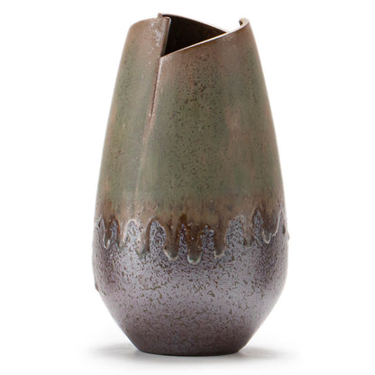 Decorative ceramic vase with a textured surface on a white background