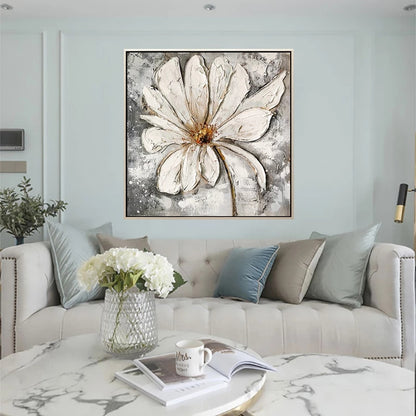 Living room with a large abstract flower painting on the wall above a sofa.