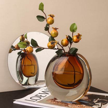 Decorative vase with branches and fruits on a table