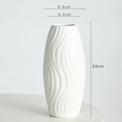 White ceramic vase with wavy design and dimensions on a light gray background