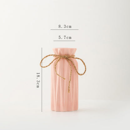 Pink bottle with a string, shown with measurements on a white background