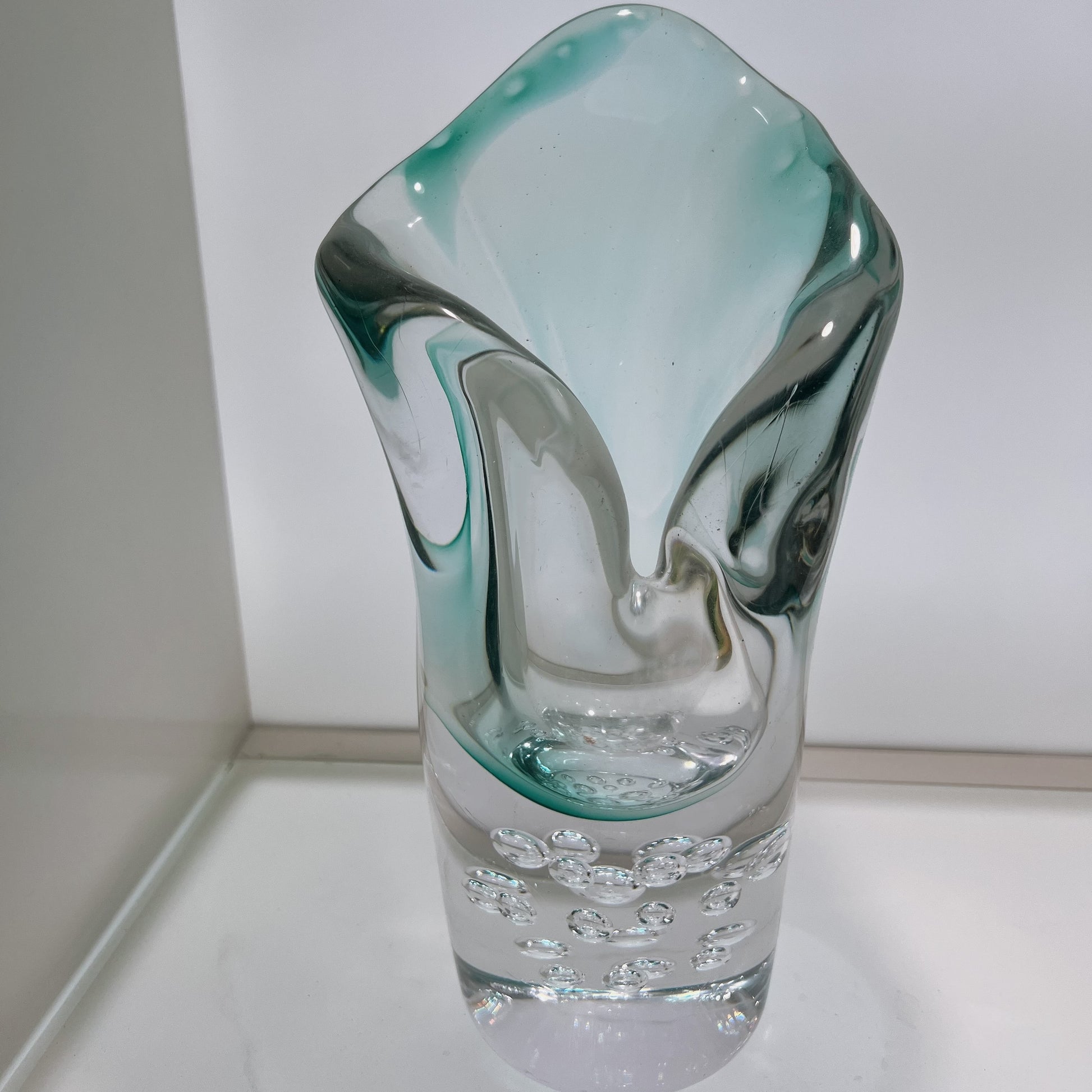 Glass vase with a unique design on a white surface