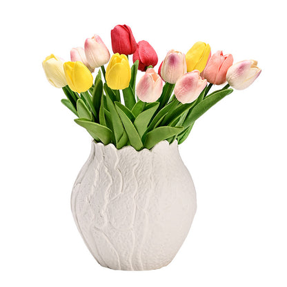 White textured vase with colorful tulips on a white background