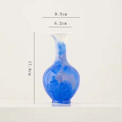 Blue ceramic vase with dimensions on a white background