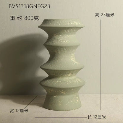 Green ceramic vase with measurements on a neutral background