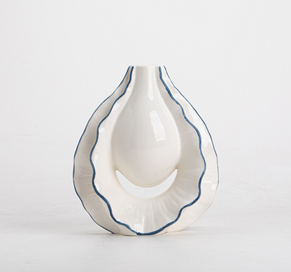 White ceramic vase with blue rim on a light gray background