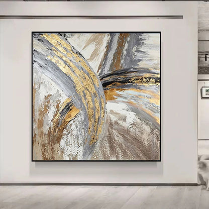 Abstract art piece with gold and gray tones on a white wall.