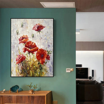 Framed abstract painting of red flowers on a teal wall in a modern room.