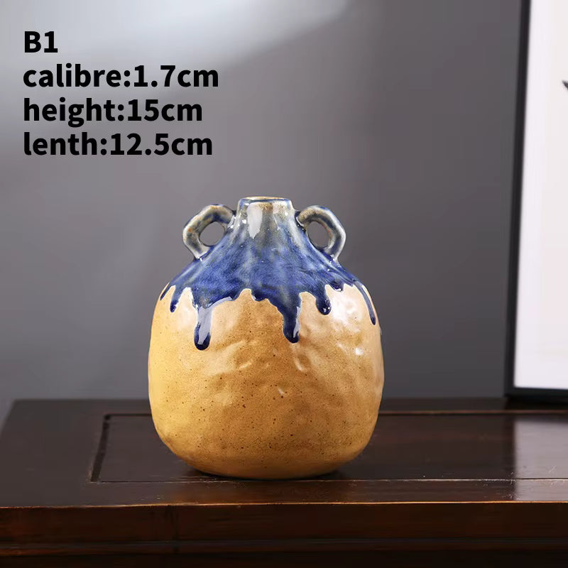 Ceramic vase with blue and beige design on a wooden surface